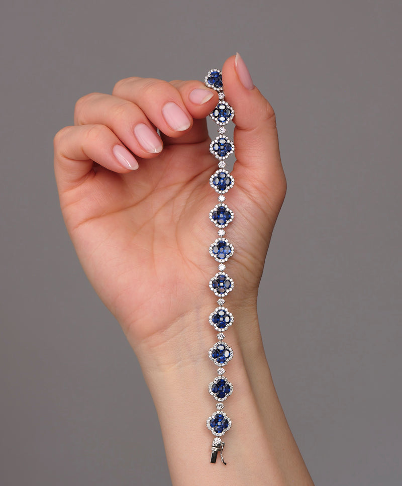 Diamond & Blue Sapphire Clover Bracelet 18kt white gold featuring 3.50ct F VS2+ diamonds and 10ct blue sapphires, handcrafted luxury jewellery by Layla Diamonds London on hand, wrist, arm