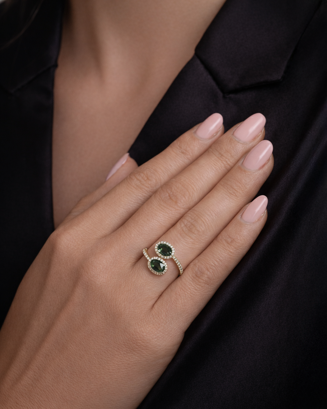 Natural teal sapphire two stone diamond halo ring in 18kt yellow gold on hand