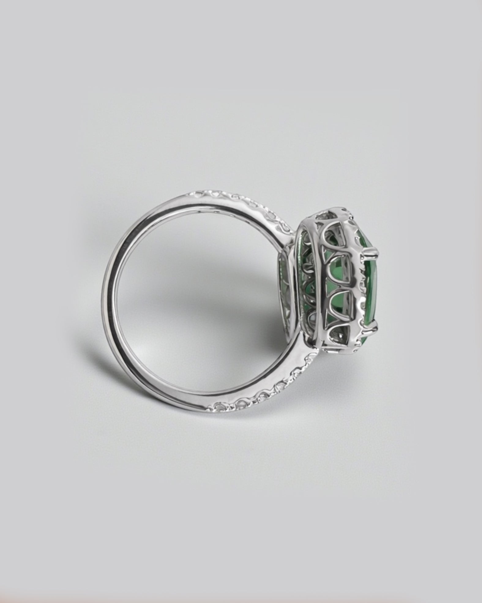 Two stone oval green tourmaline and diamond halo ring in platinum