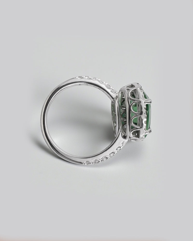 Two stone oval green tourmaline and diamond halo ring in platinum