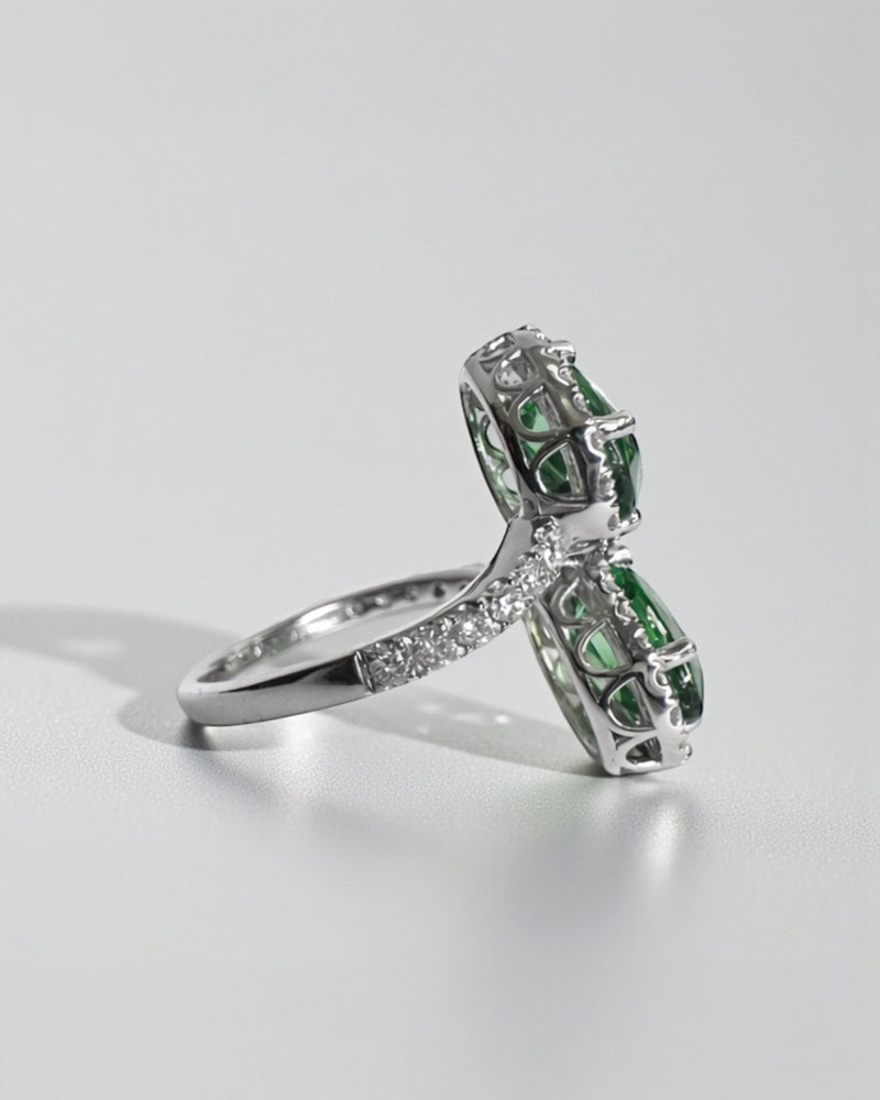 Two stone oval green tourmaline and diamond halo ring in platinum