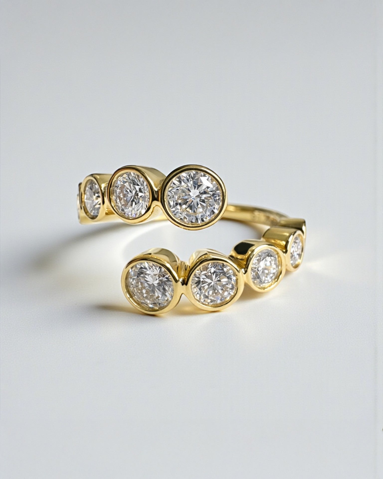Bezel set diamond bubble wrap ring with round brilliant diamonds in yellow gold