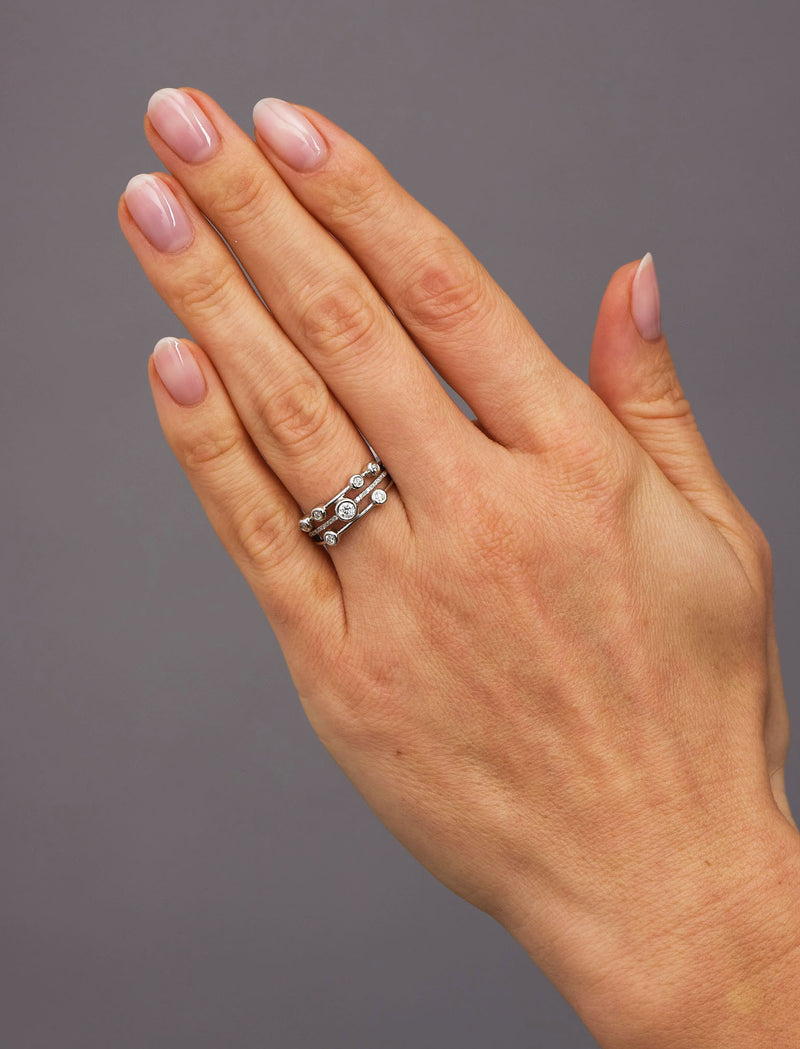Close-up detail of the delicate round diamonds on this mini bubble style diamond rings for women.
