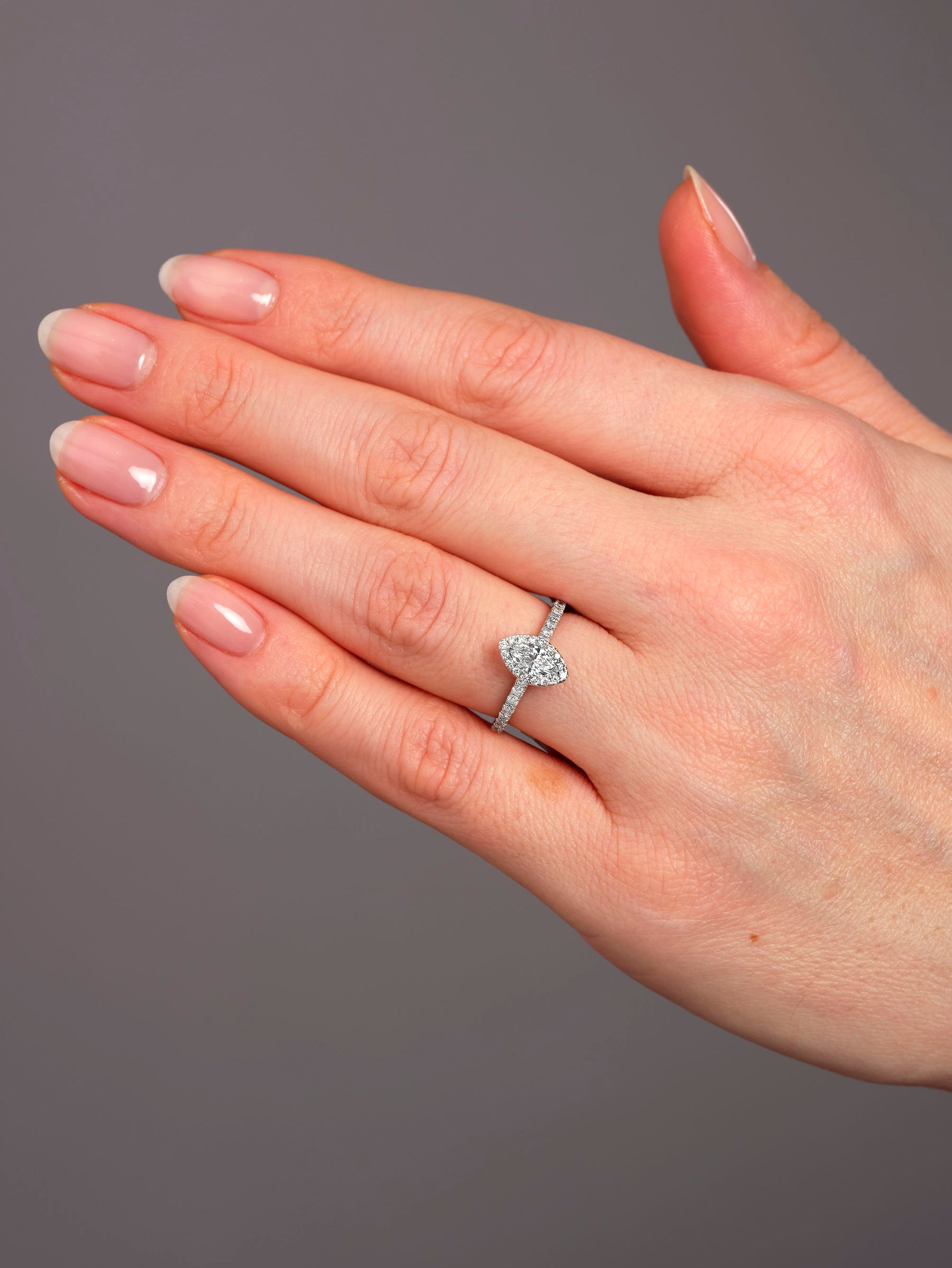 Close-up of a 0.35ct cushion cut diamond in a marquise engagement ring diamond style setting.