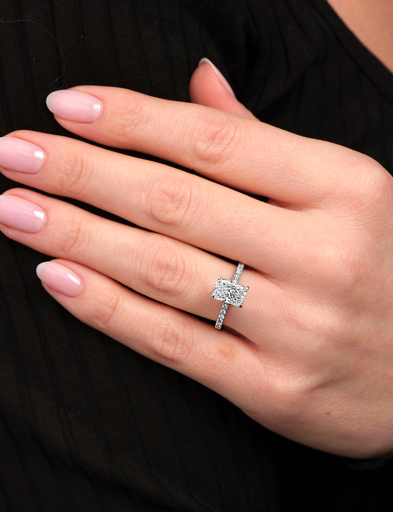 Lab grown 2ct radiant cut diamond engagement ring with hidden halo and pavé diamond shoulders platinum 18kt white gold on hand