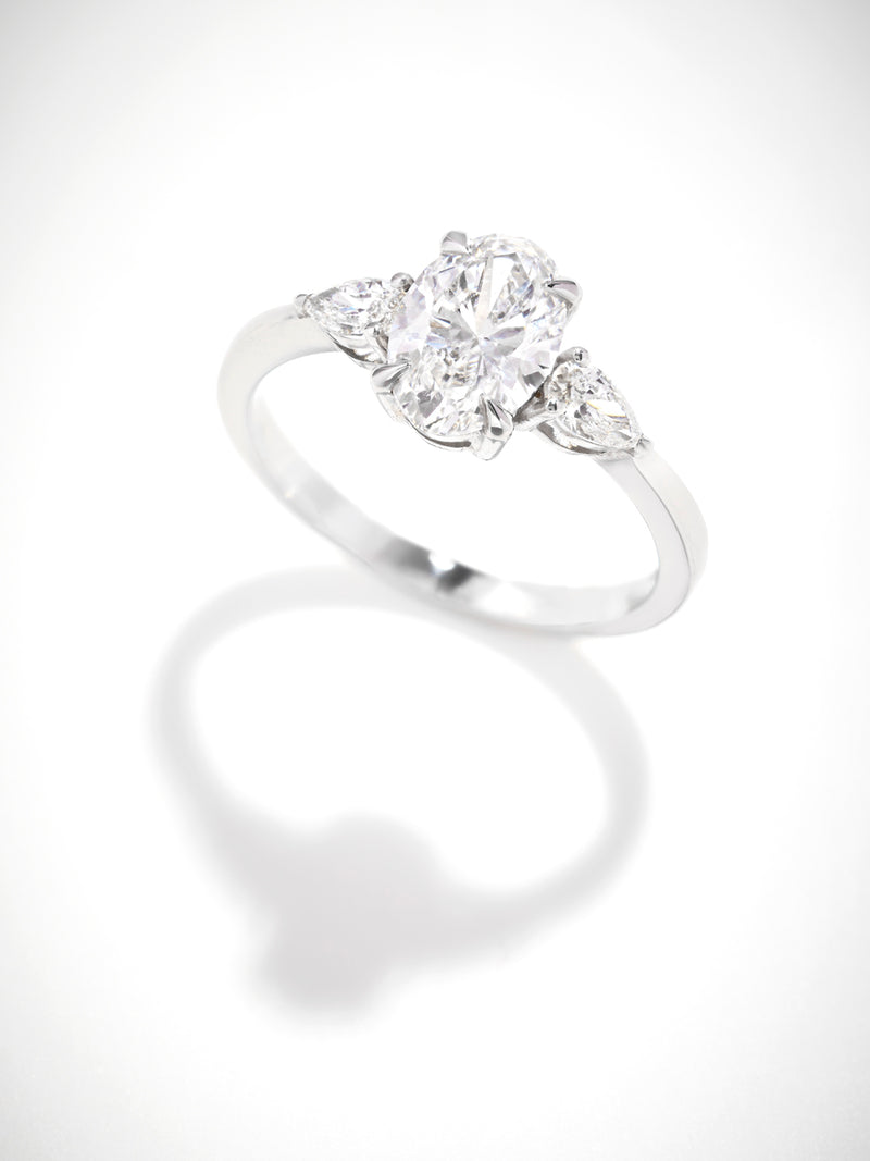 1.25ct oval cut lab grown diamond trilogy engagement ring with pear cut side diamonds by Layla Diamonds.