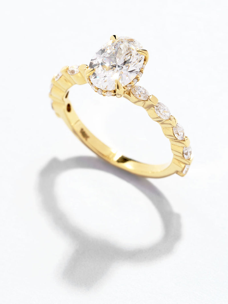 1.50ct oval cut lab grown diamond engagement ring with marquise and round diamond band and hidden halo by Layla Diamonds.