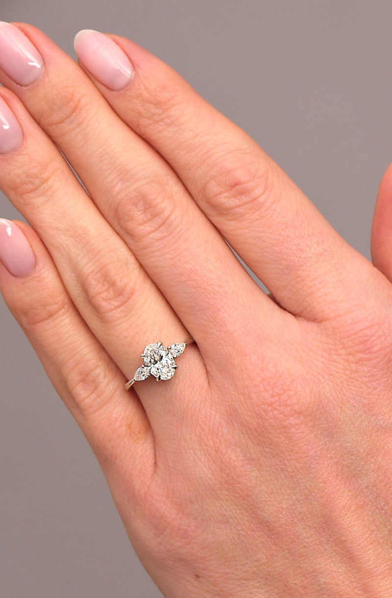1.25ct oval cut lab grown diamond trilogy engagement ring with pear cut side diamonds by Layla Diamonds.