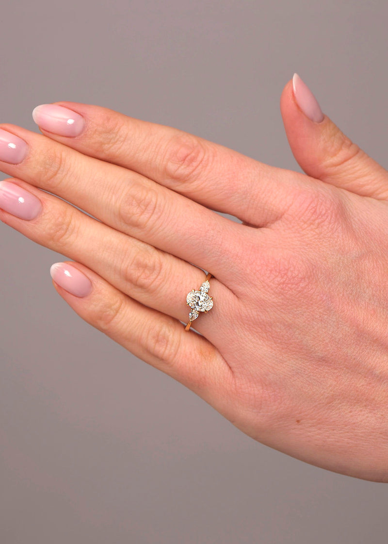 1.25ct oval cut lab grown diamond trilogy engagement ring with pear cut side diamonds by Layla Diamonds.