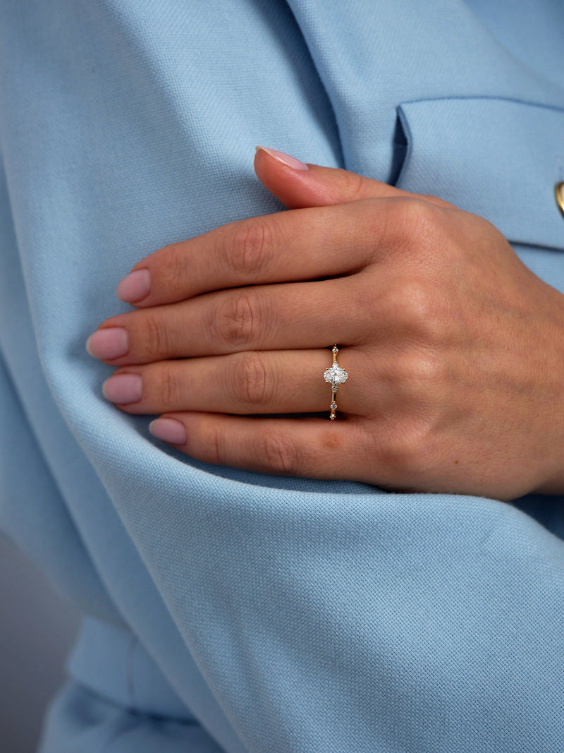0.50ct oval cut lab grown diamond engagement ring on hand with spaced bubble diamond band by Layla Diamonds.