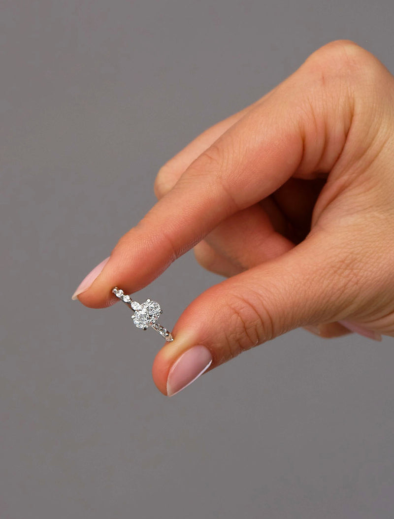 1ct oval cut lab grown diamond engagement ring with marquise and round diamond band by Layla Diamonds.