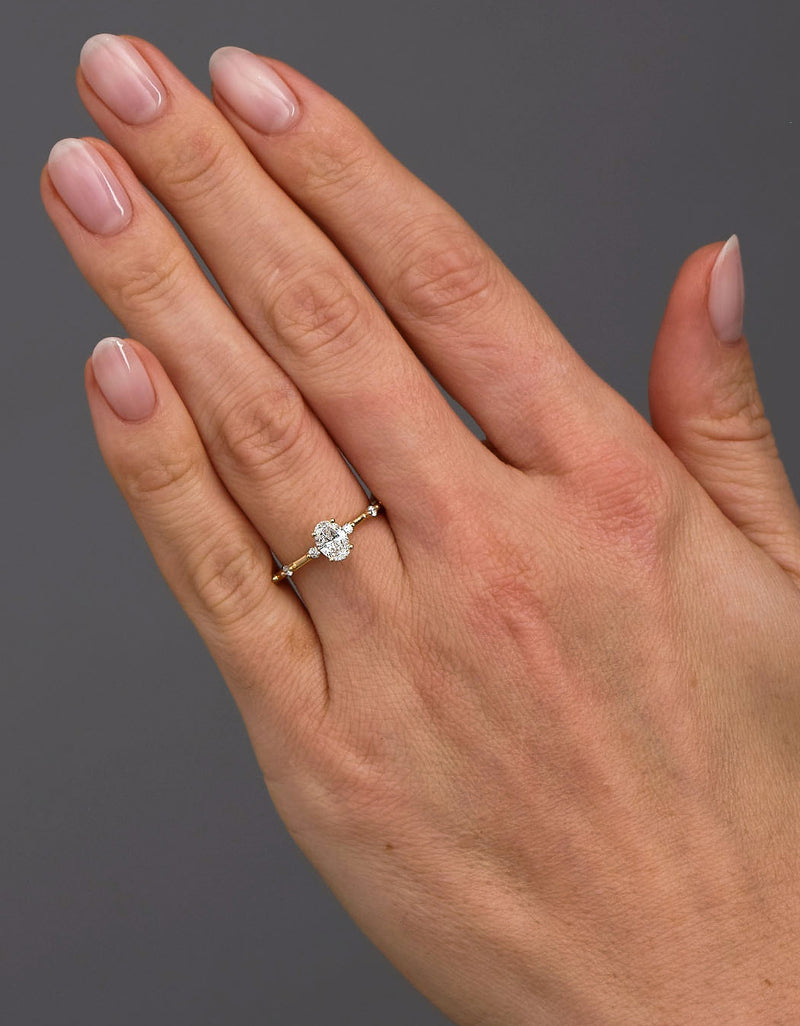 0.50ct oval cut lab grown diamond engagement ring with spaced bubble diamond band by Layla Diamonds.