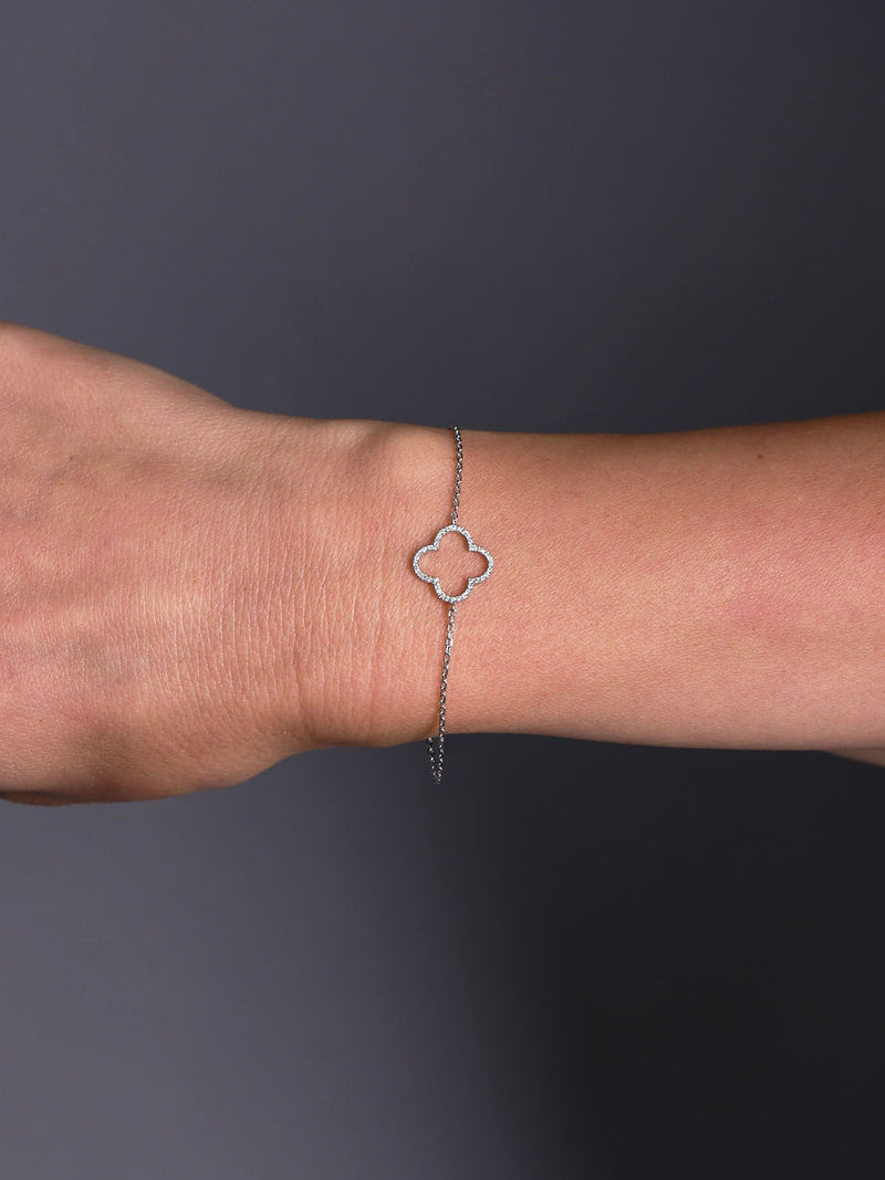 Clover Diamond Bracelet in yellow gold featuring delicate clover motifs set with round brilliant diamonds, photographed on wrist, arm, hand
