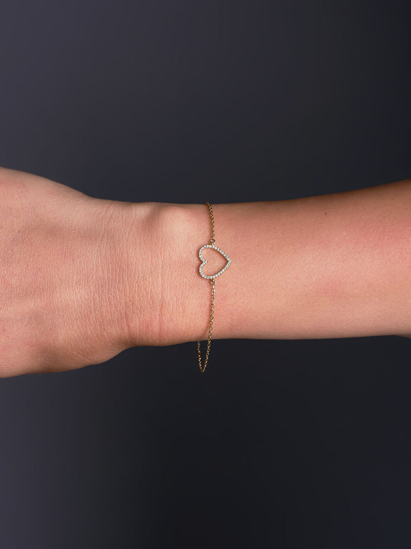 Heart Diamond Bracelet in yellow gold featuring delicate heart motifs set with round brilliant diamonds, photographed on wrist, hand arm