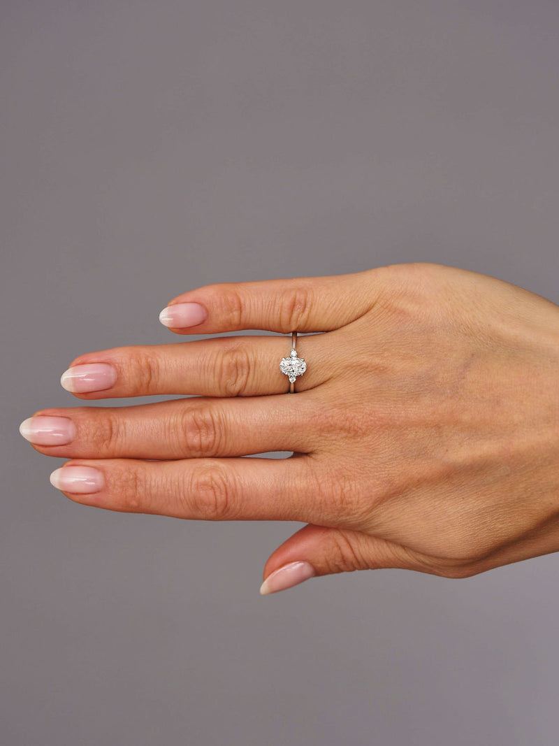 1ct oval cut lab grown diamond trilogy engagement ring with round brilliant side diamonds and cathedral band by Layla Diamonds.
