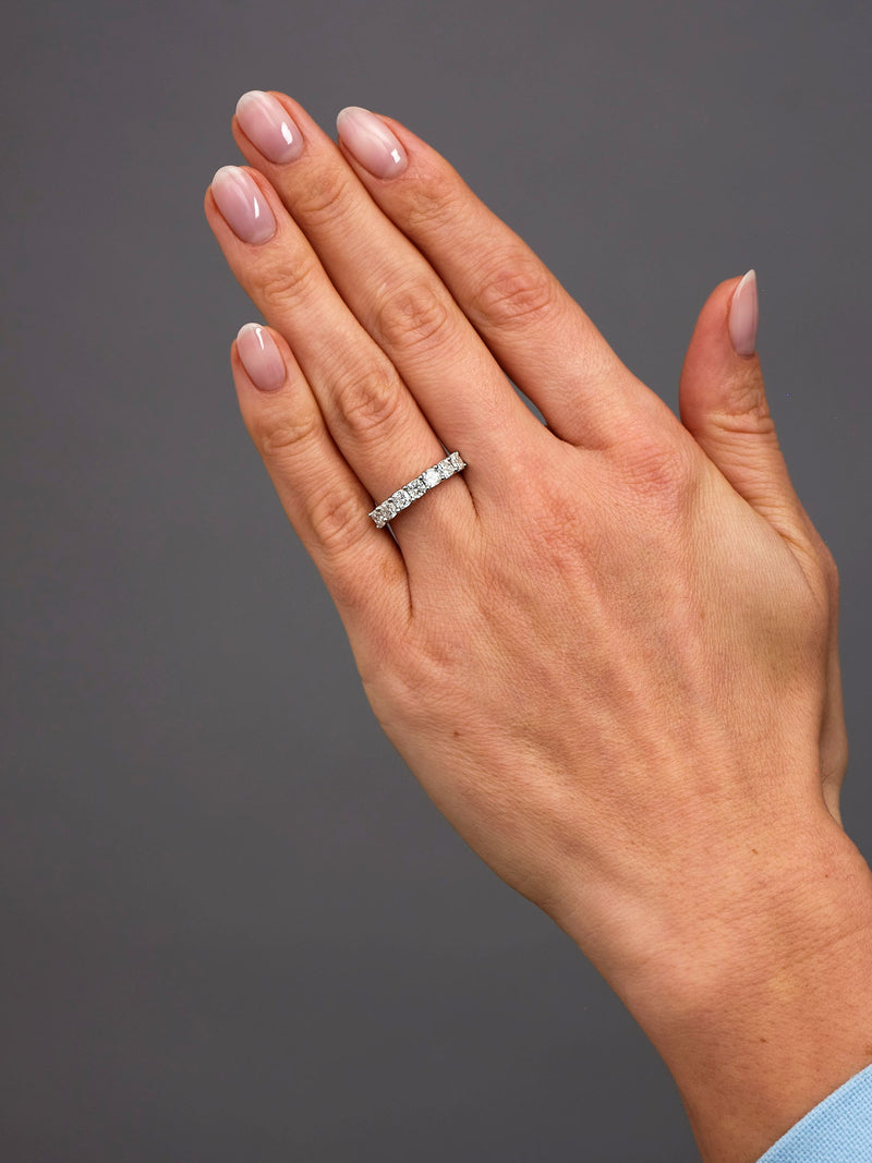 Close-up detail of the brilliant cushion cut diamonds on this high-end diamond engagement band style.