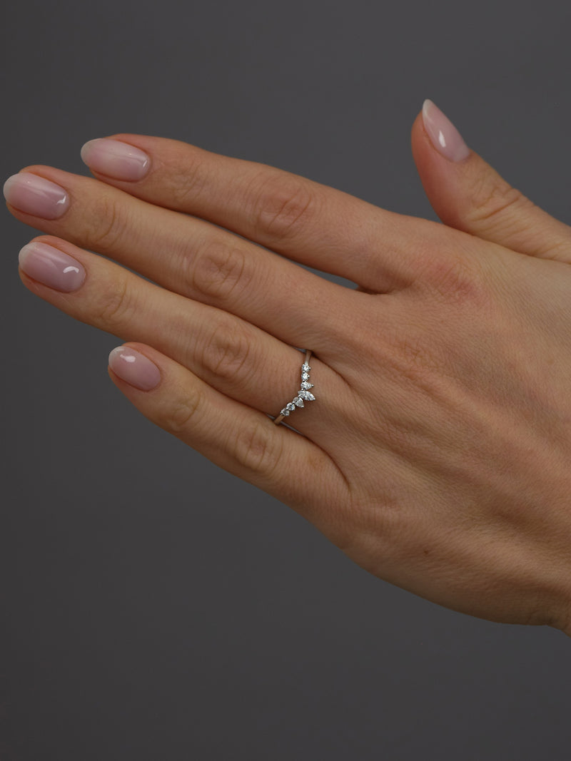 Fancy wishbone diamond band worn on a finger, showcasing a stylish and modern diamond engagement band design.