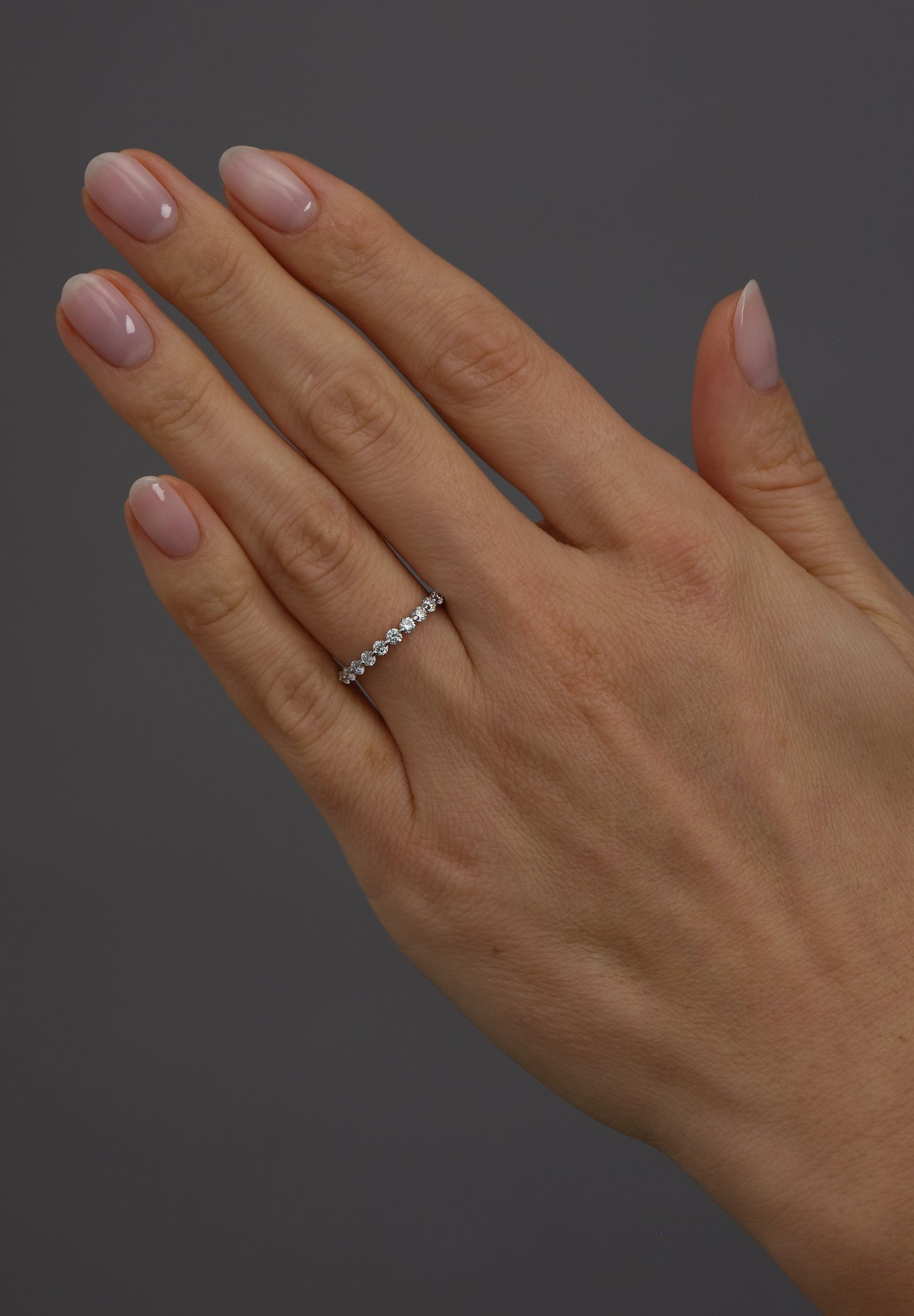 Diamond bubble band worn on a finger, showcasing a popular diamond rings for women design.