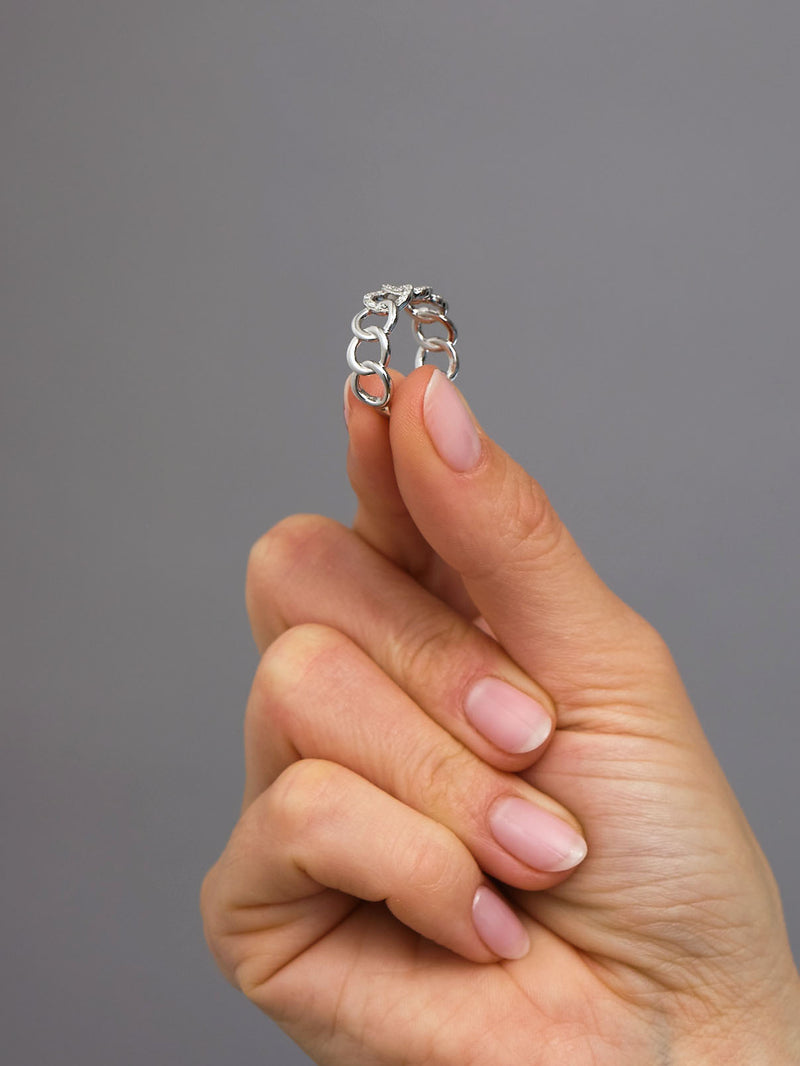 Perspective view of a high-quality curb chain link ring, perfect for pairing with other diamond rings for women.