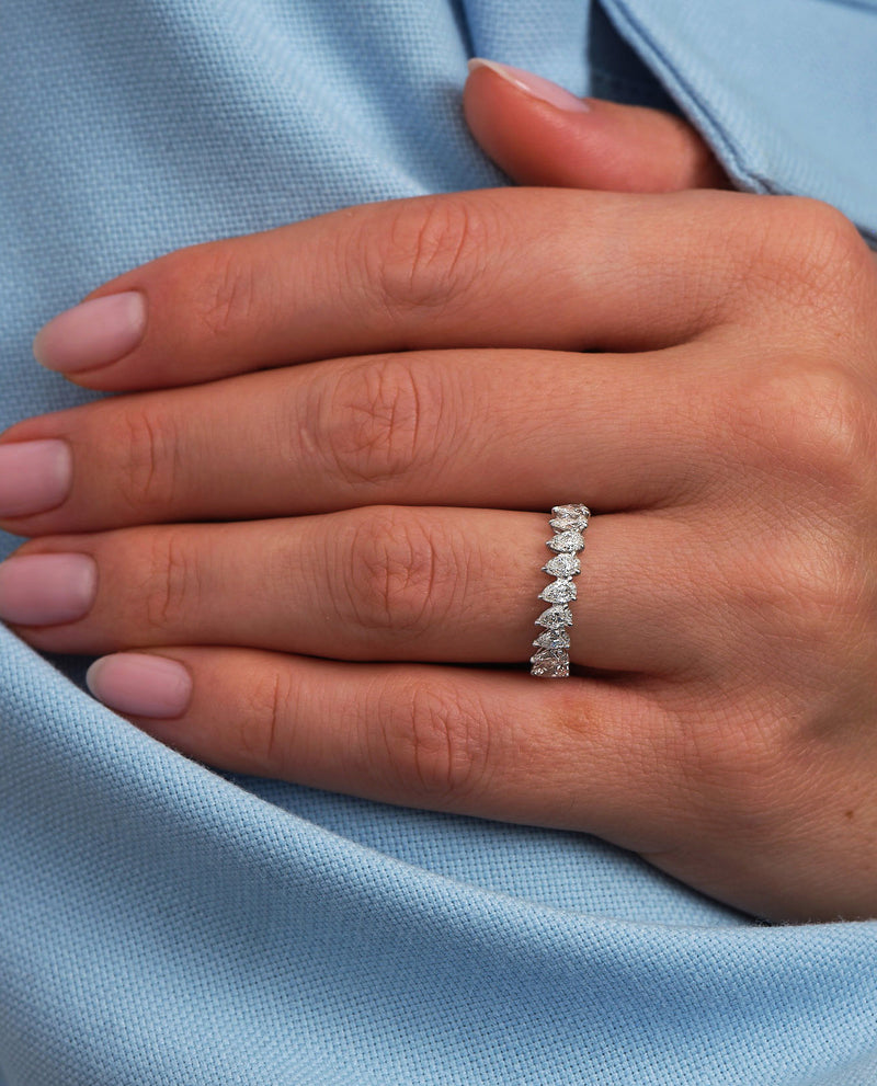 A unique slanted pear cut eternity band from our exclusive diamond rings for women collection.