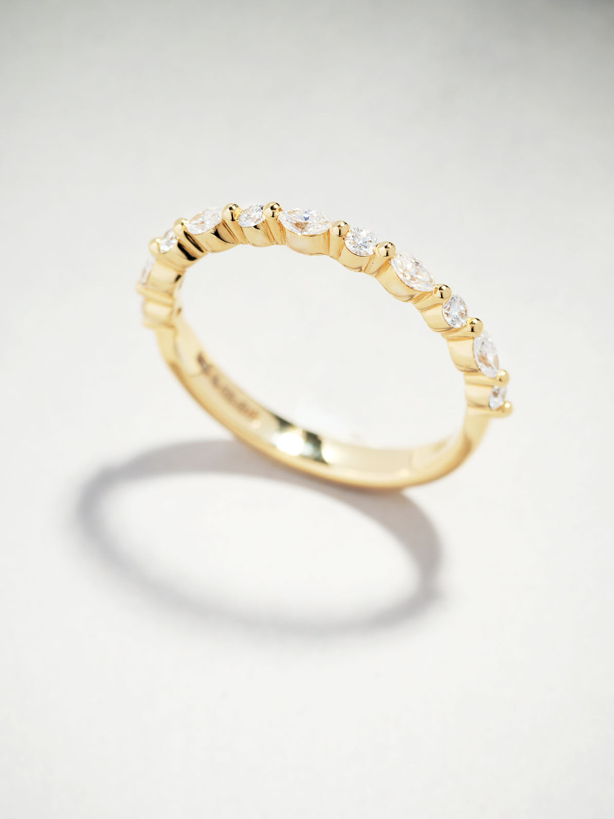 Side profile of the marquise and round cut diamond wedding bands.