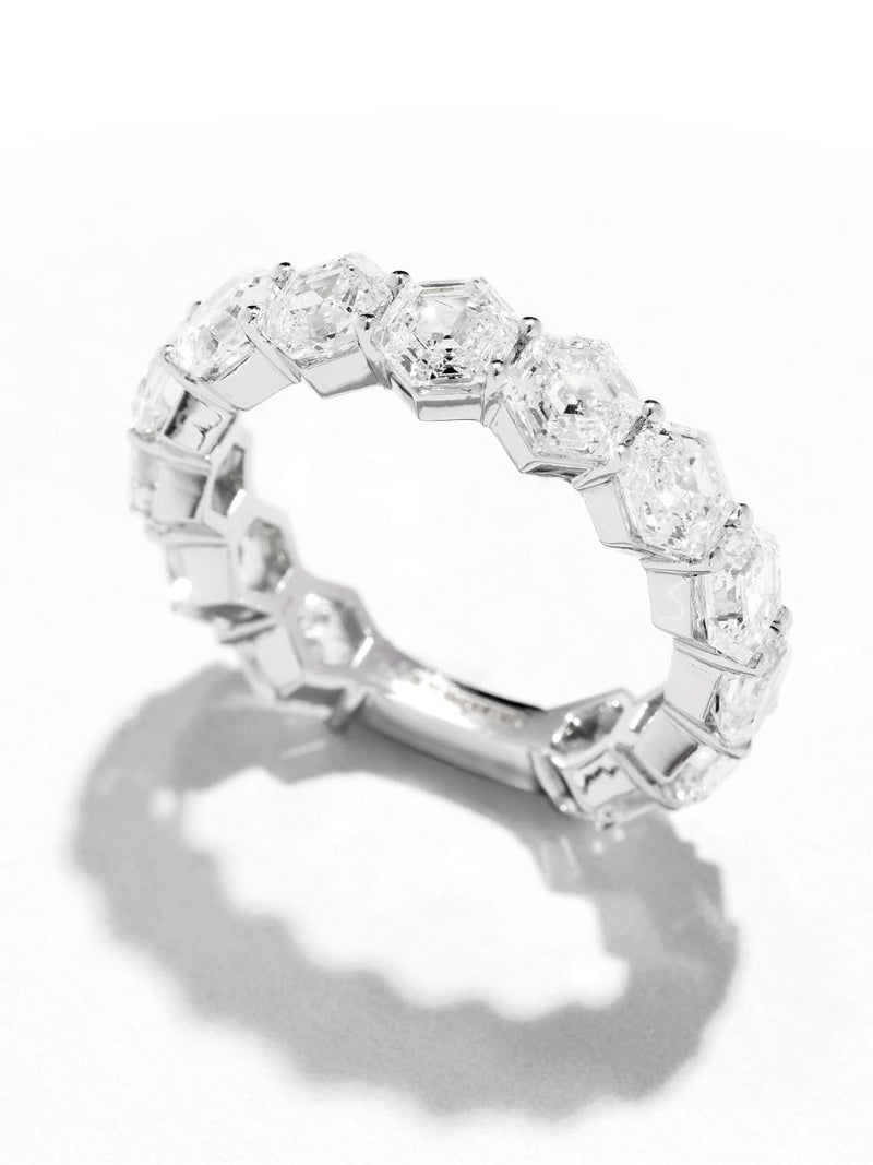 Close-up detail of the fine hexagon cut diamonds on this contemporary diamond engagement band style.