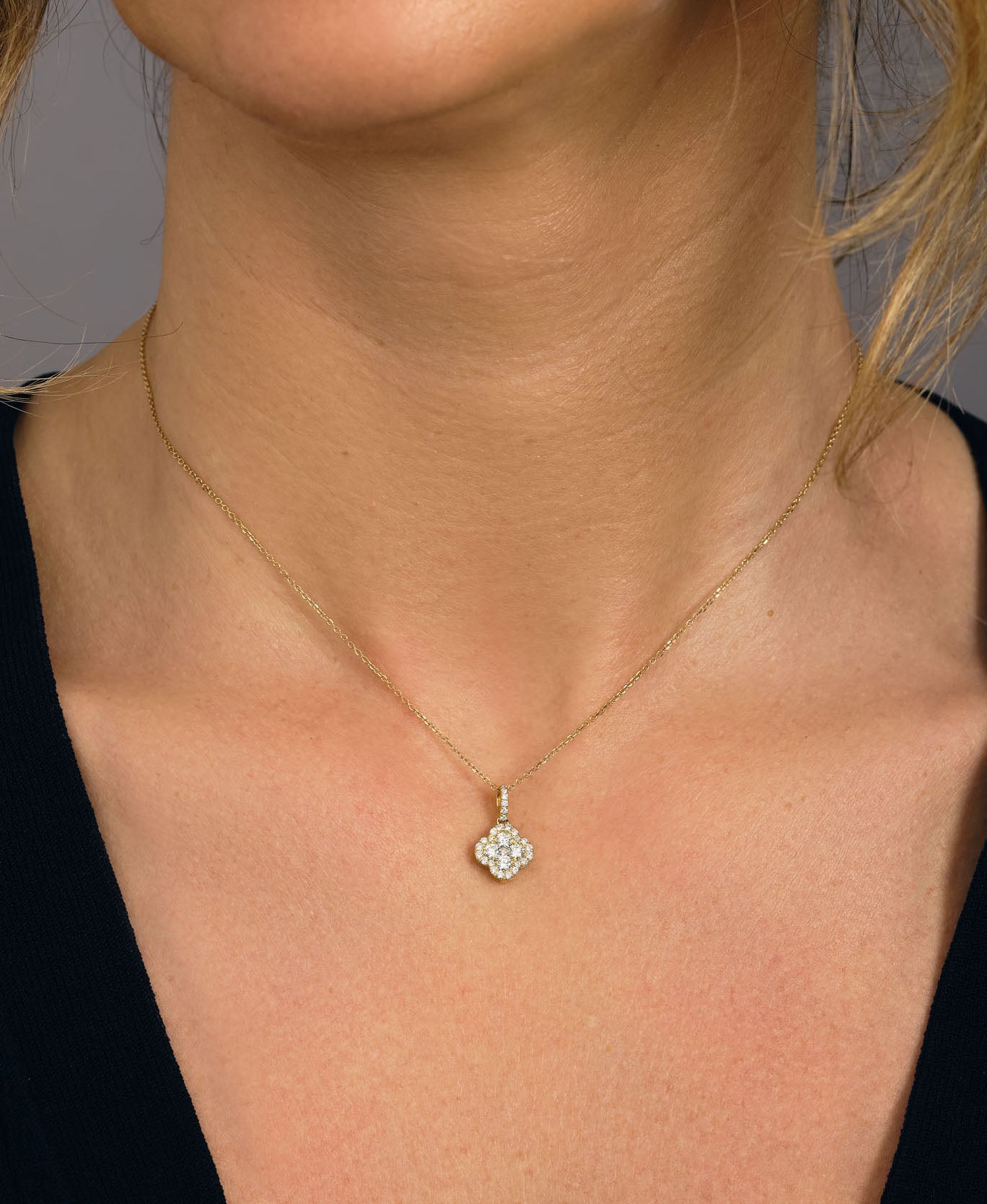 Elegant diamond clover pendant in 18kt gold with 0.50ct round diamonds, shown on an 18-inch chain – feminine four-leaf design, perfect for everyday luxury or gifting