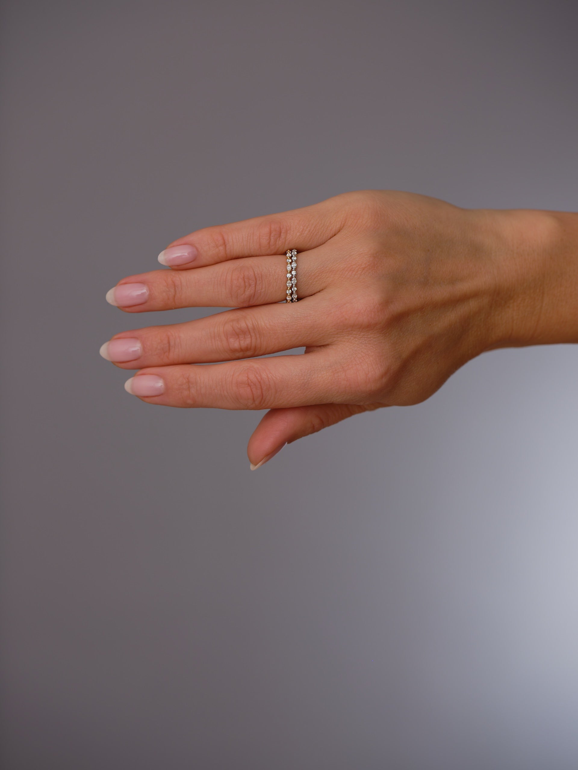 Close-up detail of the alternating marquise and round stones on this diamond wedding bands.