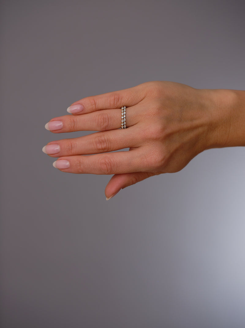 Close-up detail of the alternating marquise and round stones on this diamond wedding bands.