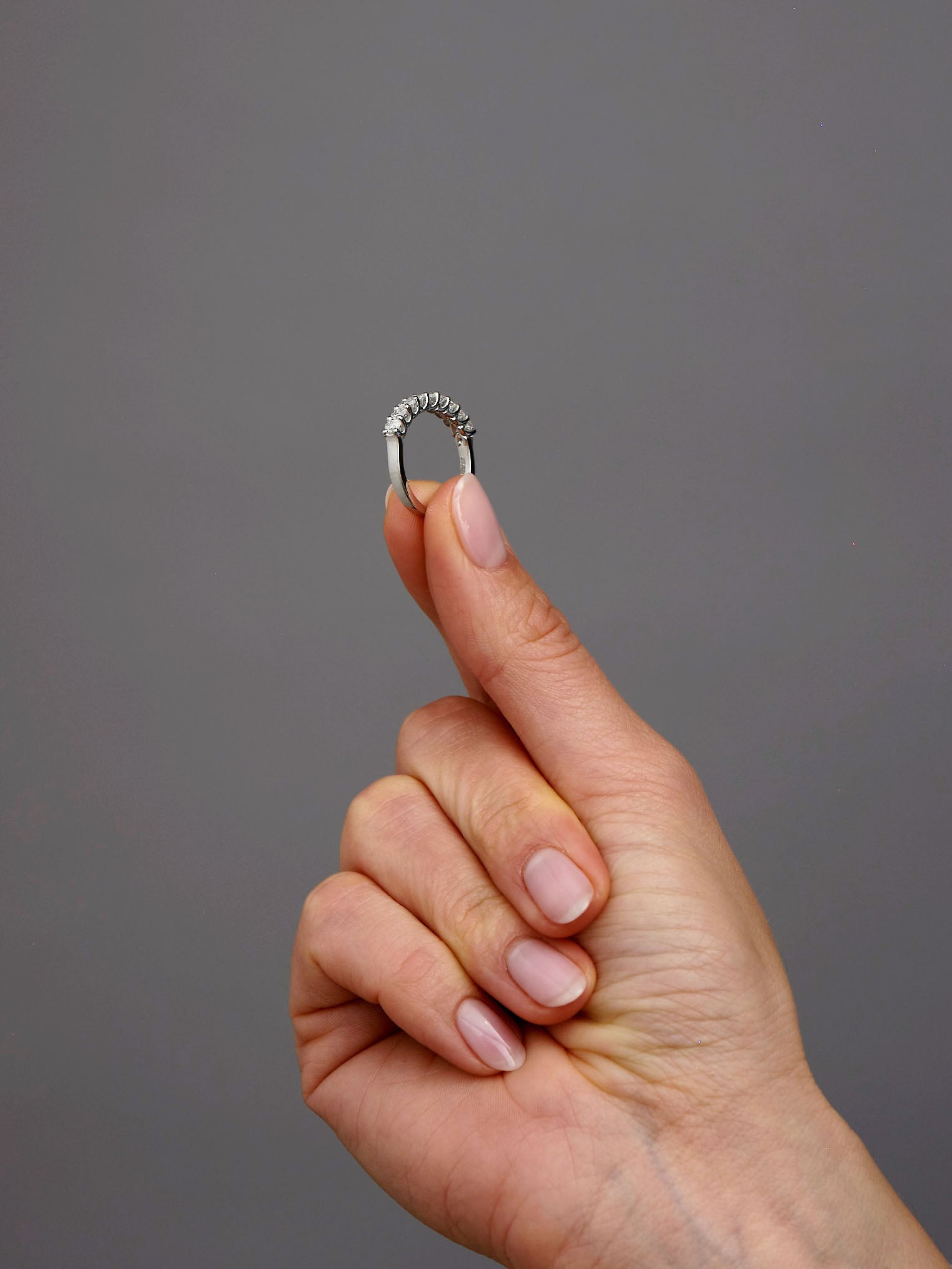 Side profile of a mini oval diamond band, part of our oval diamond engagement bands range.