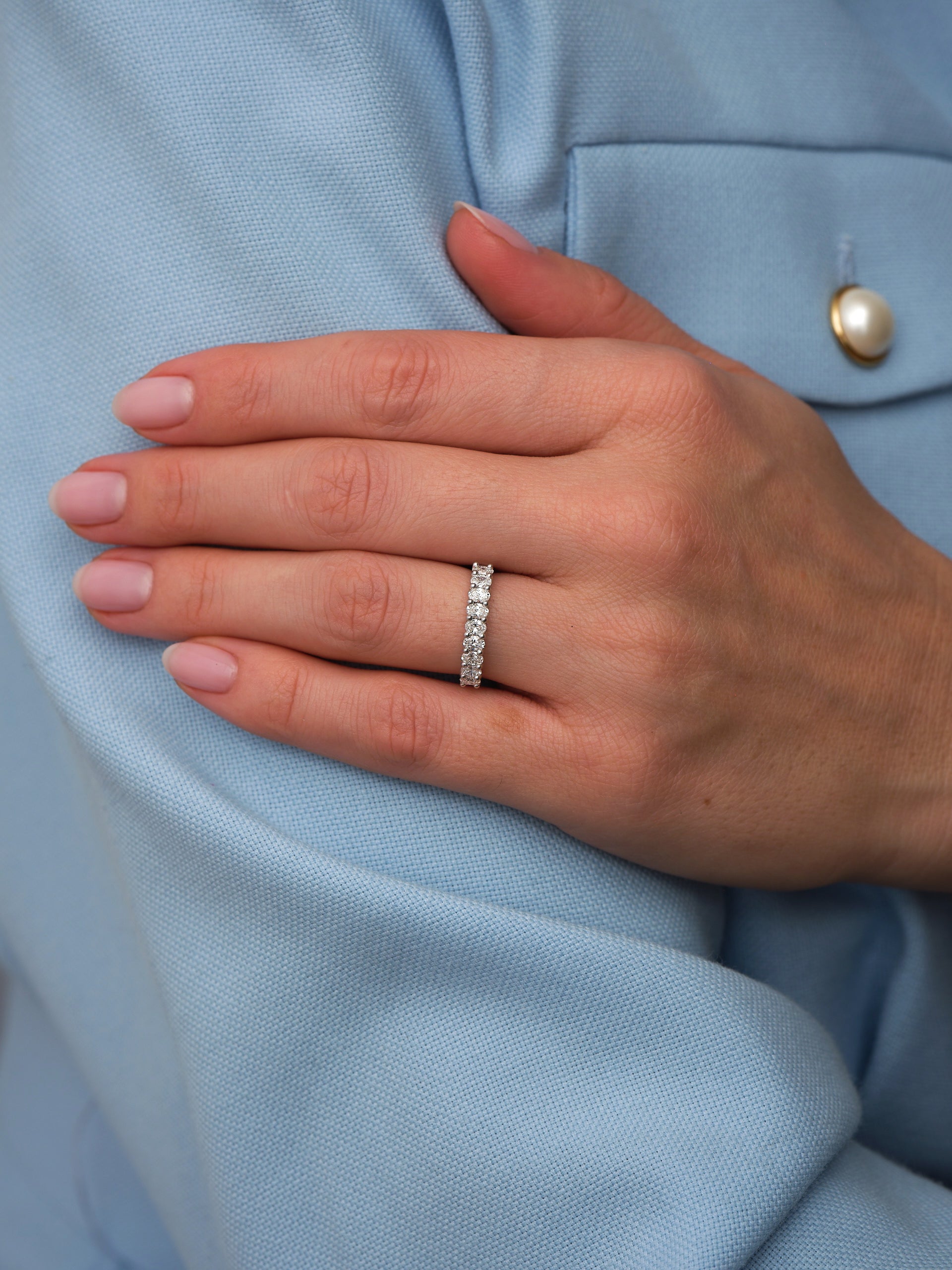 Perspective view of a mini oval diamond band, perfect for pairing with oval diamond engagement bands.