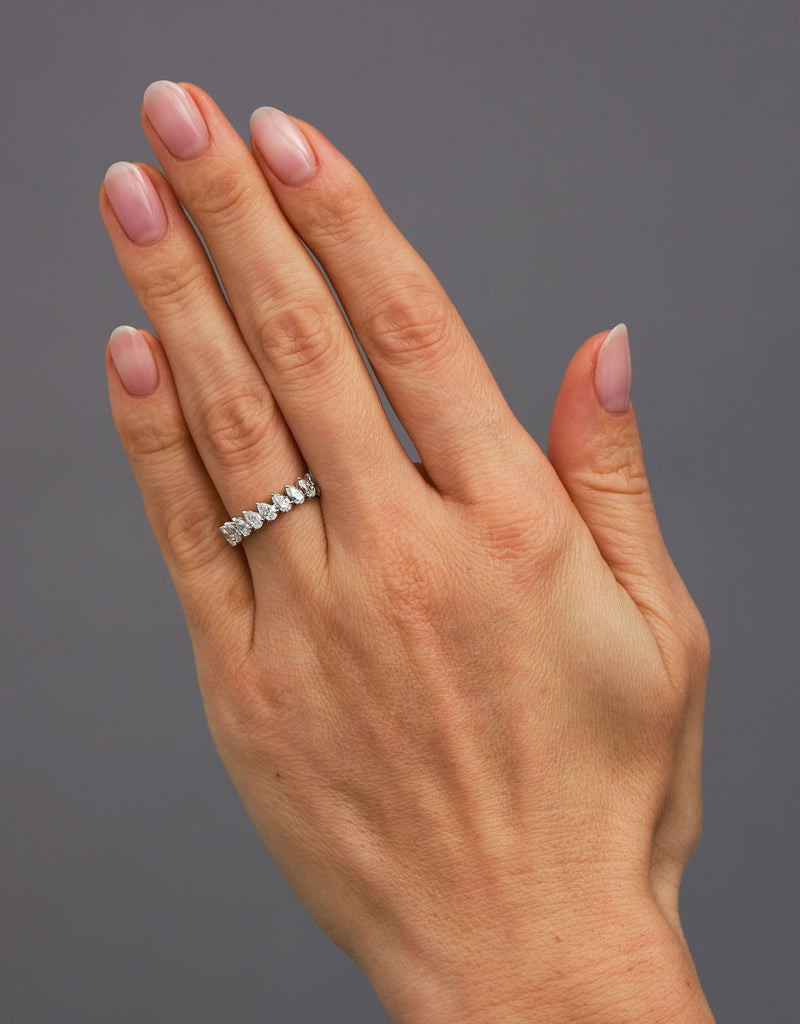Close-up detail of the beautifully aligned slanted pear shape stones on this diamond rings for women style.