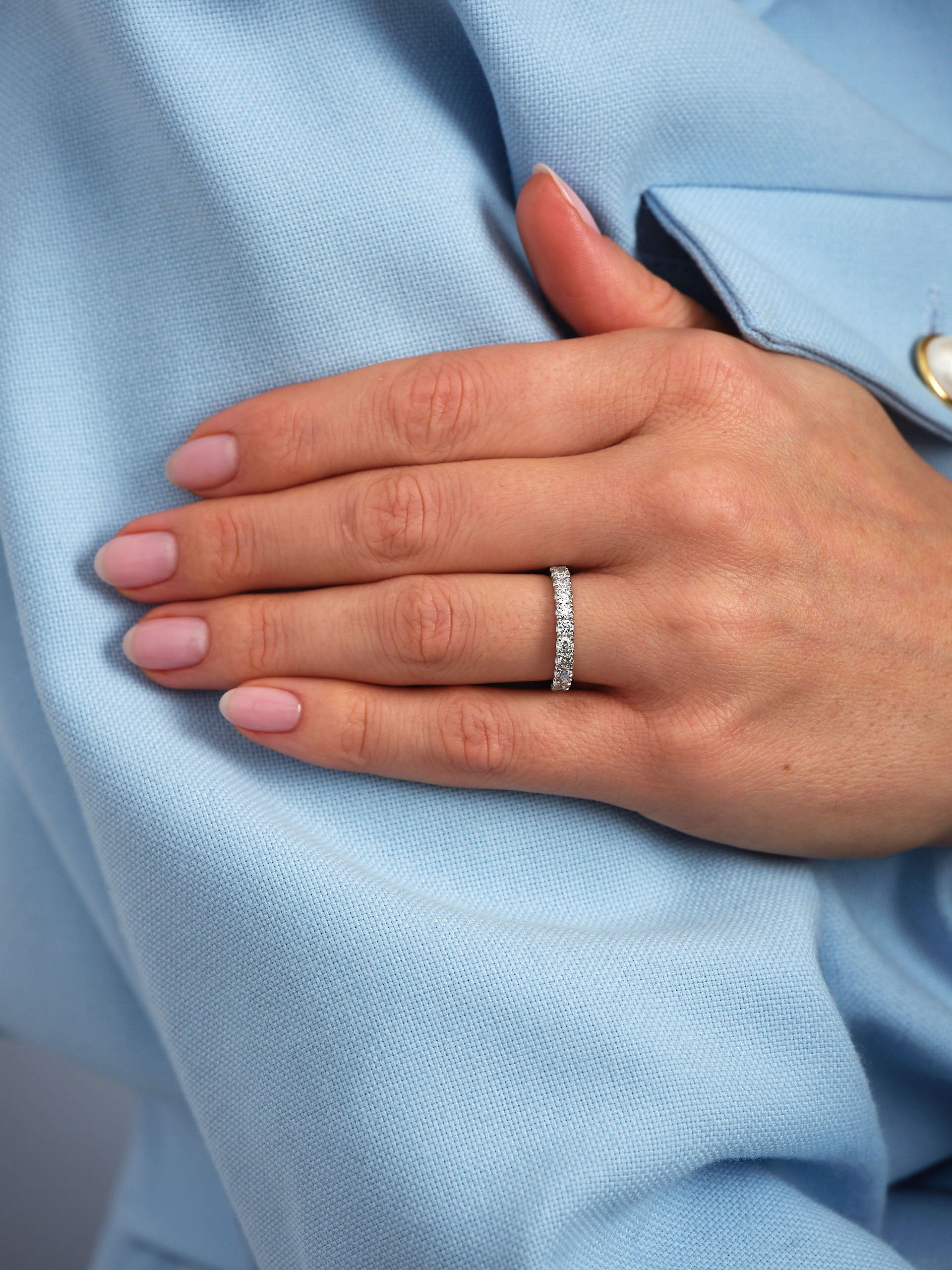 Perspective view of a comfort fit lab grown half eternity ring for women's diamond wedding bands sets.